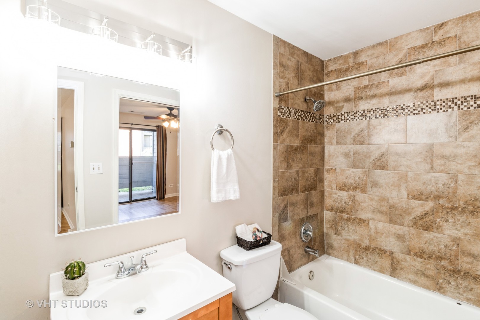 1915 North Hicks Road, Unit 106 Palatine, IL 60074 - Photo 10 of 11 a bathroom with a sink a toilet and shower