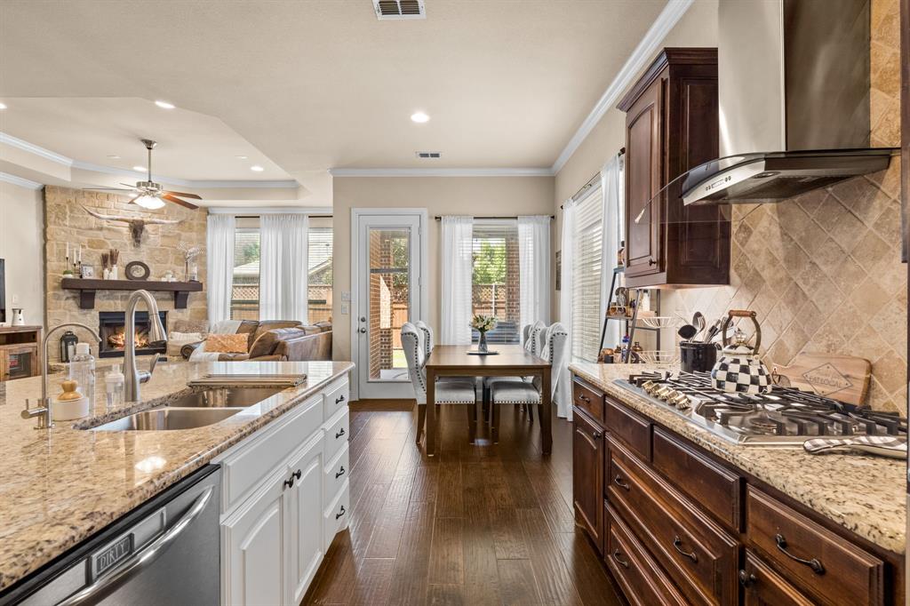 a kitchen with stainless steel appliances granite countertop a sink stove and cabinets