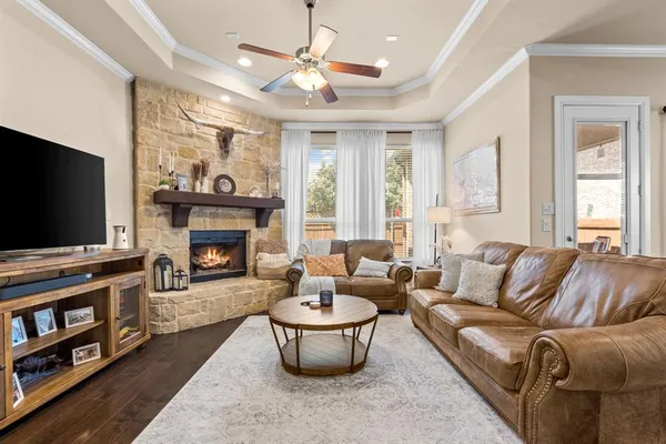 a living room with furniture a flat screen tv and a fireplace