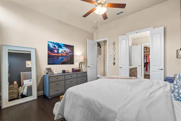 a bedroom with a large bed and a chandelier