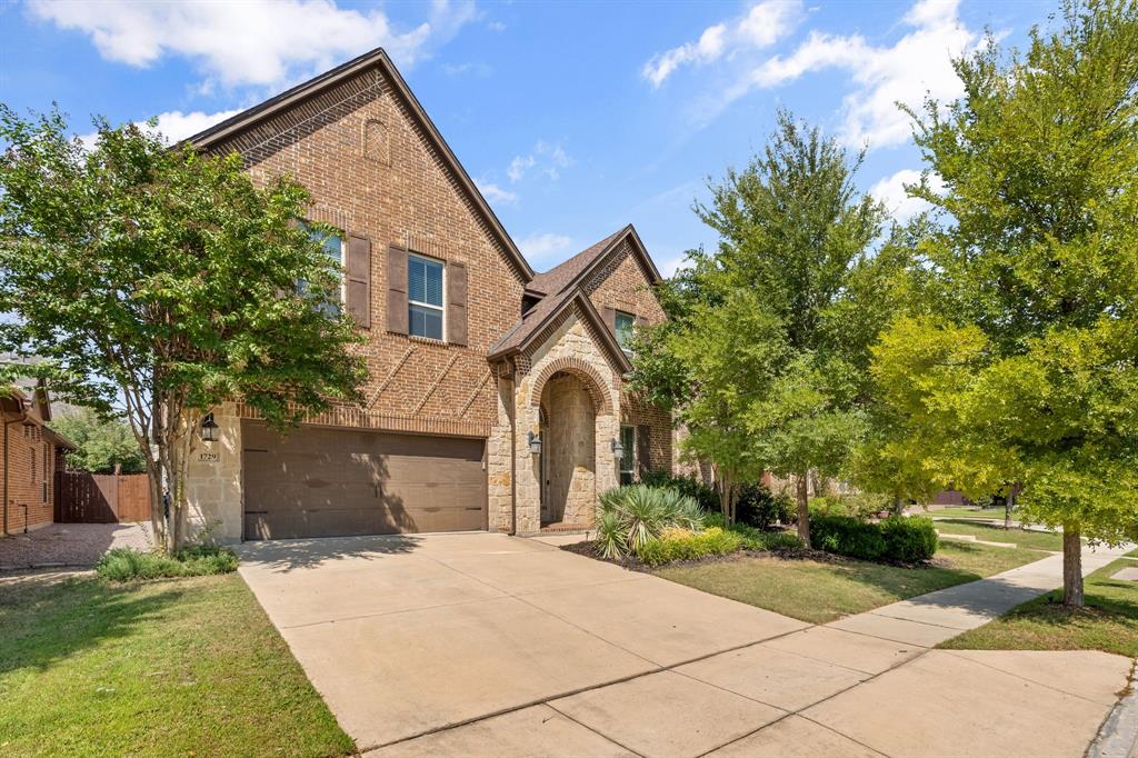 1729 Halifax Street Roanoke, TX 76262 - Photo 2 of 40 a front view of a house with a yard and trees