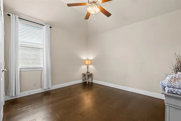 a view of a room with wooden floor and windows