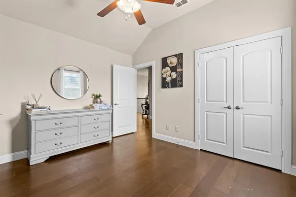 a room with a mirror and a dresser in it