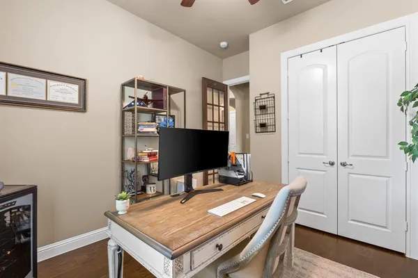 a view of a workspace with furniture and wooden floor