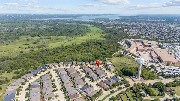 an aerial view of a house with a yard
