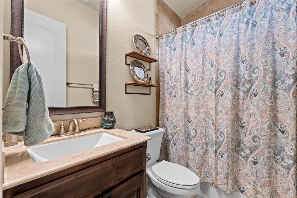 1729 Halifax Street Roanoke, TX 76262 - Photo 4 of 40 a bathroom with a granite countertop sink and a mirror