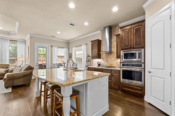 a kitchen with granite countertop a stove and kitchen island