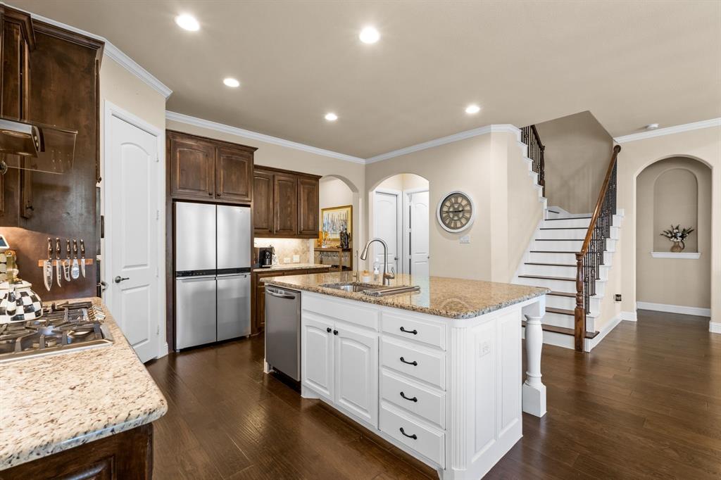 1729 Halifax Street Roanoke, TX 76262 - Photo 9 of 40 a kitchen with stainless steel appliances granite countertop a refrigerator a stove a sink dishwasher and a refrigerator with wooden floor