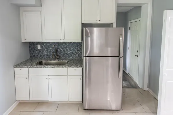 a white refrigerator freezer sitting in a kitchen