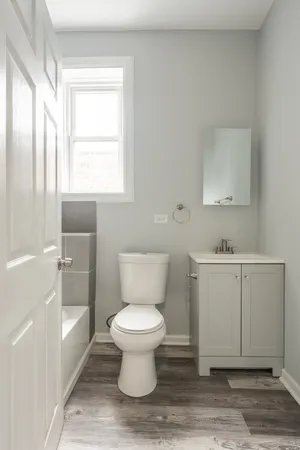 a bathroom with a sink toilet and vanity