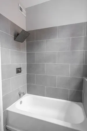a white bath tub and a shower