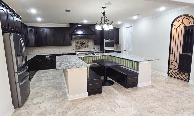 127 Bridgewater Onalaska, TX 77360 - Photo 9 of 34 a kitchen with stainless steel appliances granite countertop a refrigerator and a stove