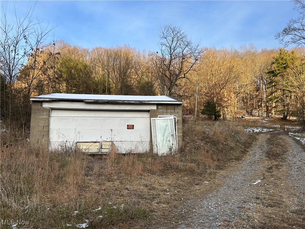 2575 Joyce Hill Road Southwest New Philadelphia, OH 44663 - Photo 11 of 11 Garage with a forest view