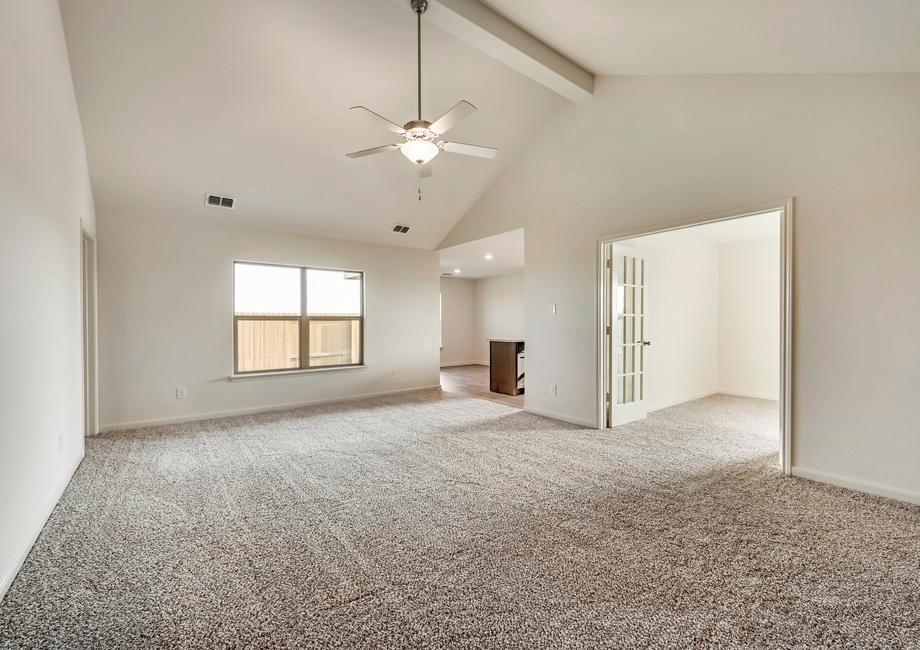 13617 Mineral Road Ponder, TX 76259 - Photo 5 of 10 Spacious room featuring vaulted ceilings, a ceiling fan with integrated lighting, and neutral-toned carpeting