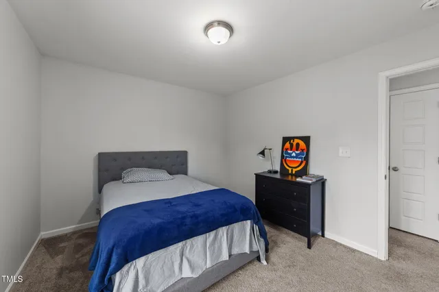 a bedroom with a bed and a table