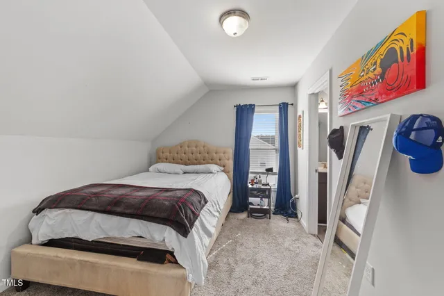 a bedroom with a bed and dresser