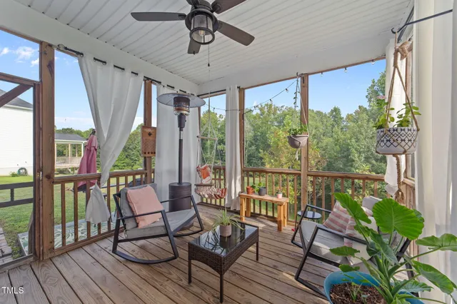 a view of a chairs and table in patio with wooden floor