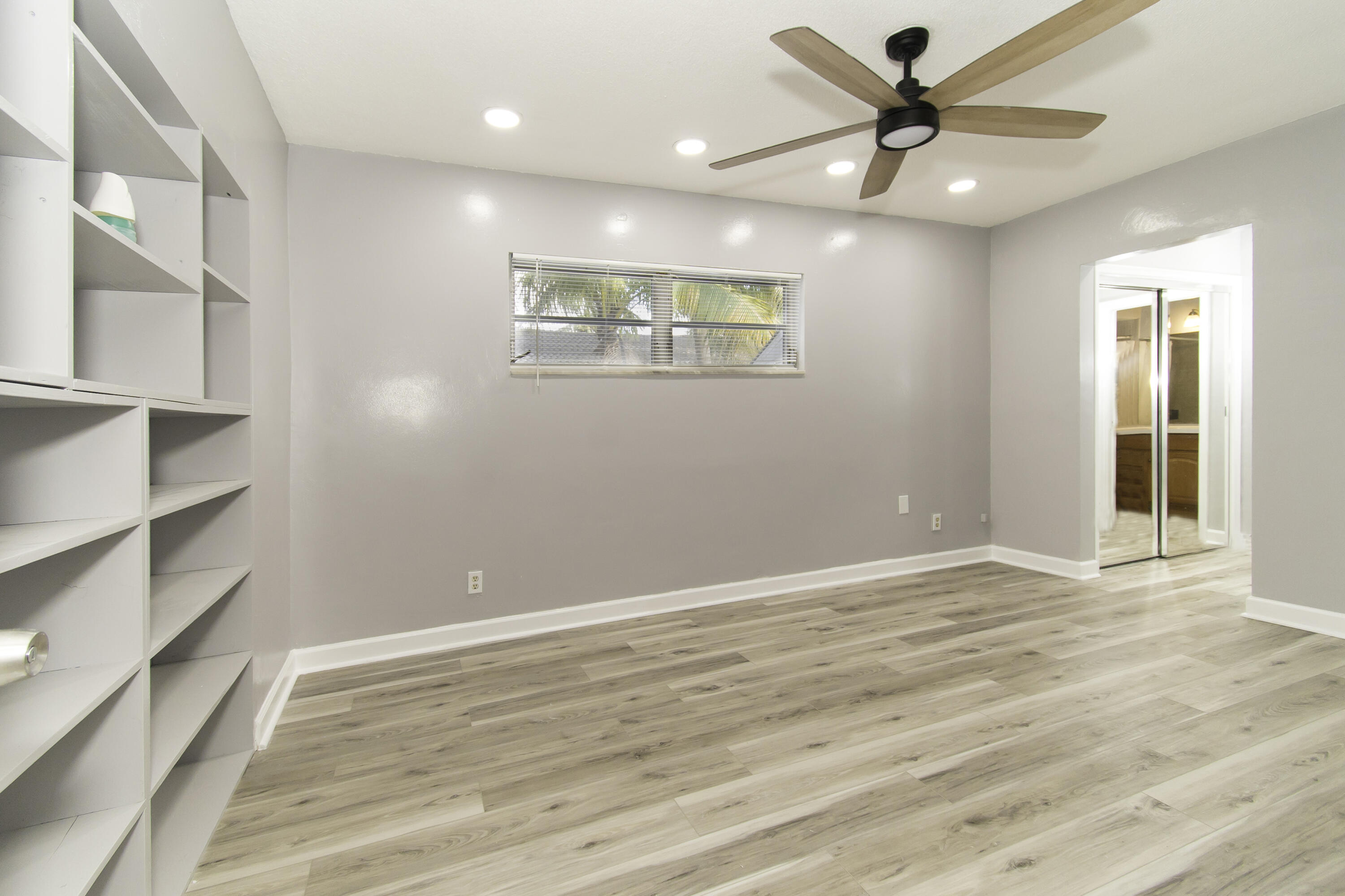 1571 Southwest 13th Drive Boca Raton, FL 33486 - Photo 14 of 21 an empty room with wooden floor and windows
