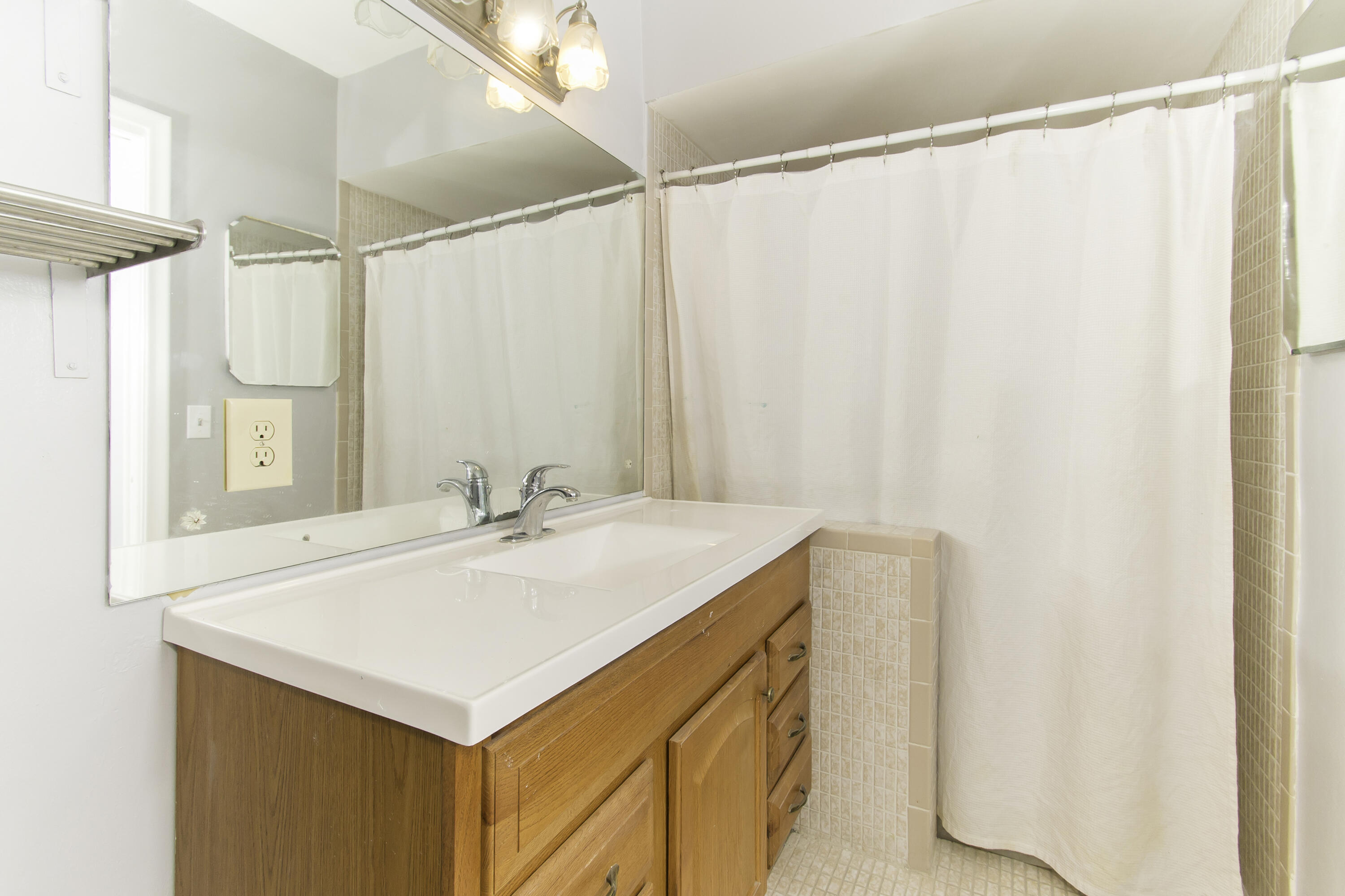 1571 Southwest 13th Drive Boca Raton, FL 33486 - Photo 16 of 21 a bathroom with a sink and a mirror