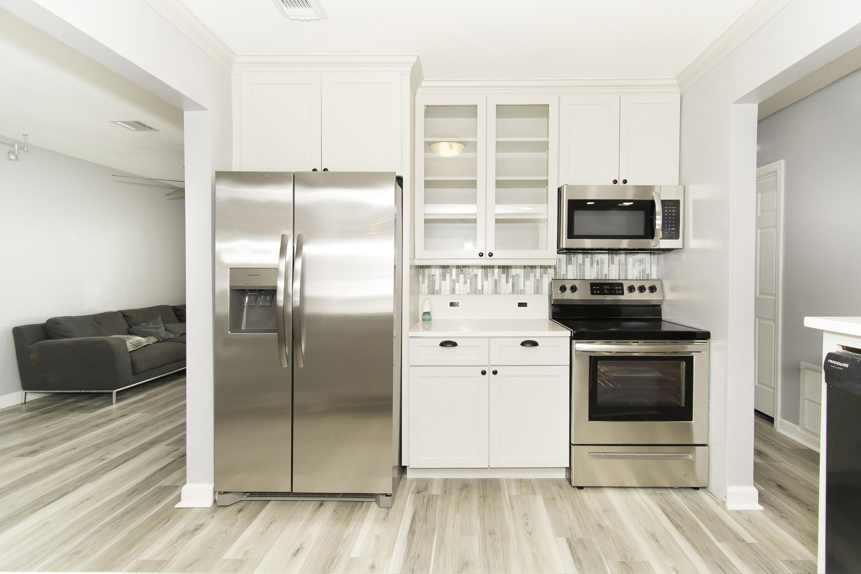 1571 Southwest 13th Drive Boca Raton, FL 33486 - Photo 2 of 21 a kitchen with stainless steel appliances a stove a microwave and a refrigerator