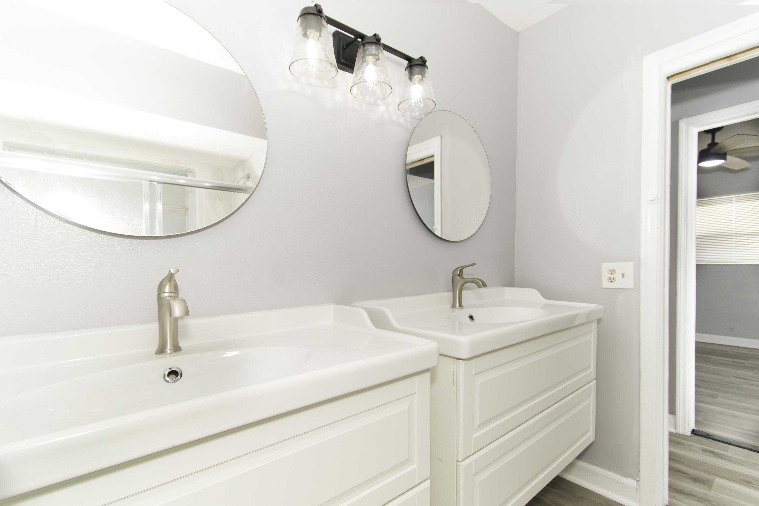 1571 Southwest 13th Drive Boca Raton, FL 33486 - Photo 8 of 21 a bathroom with a sink and mirror