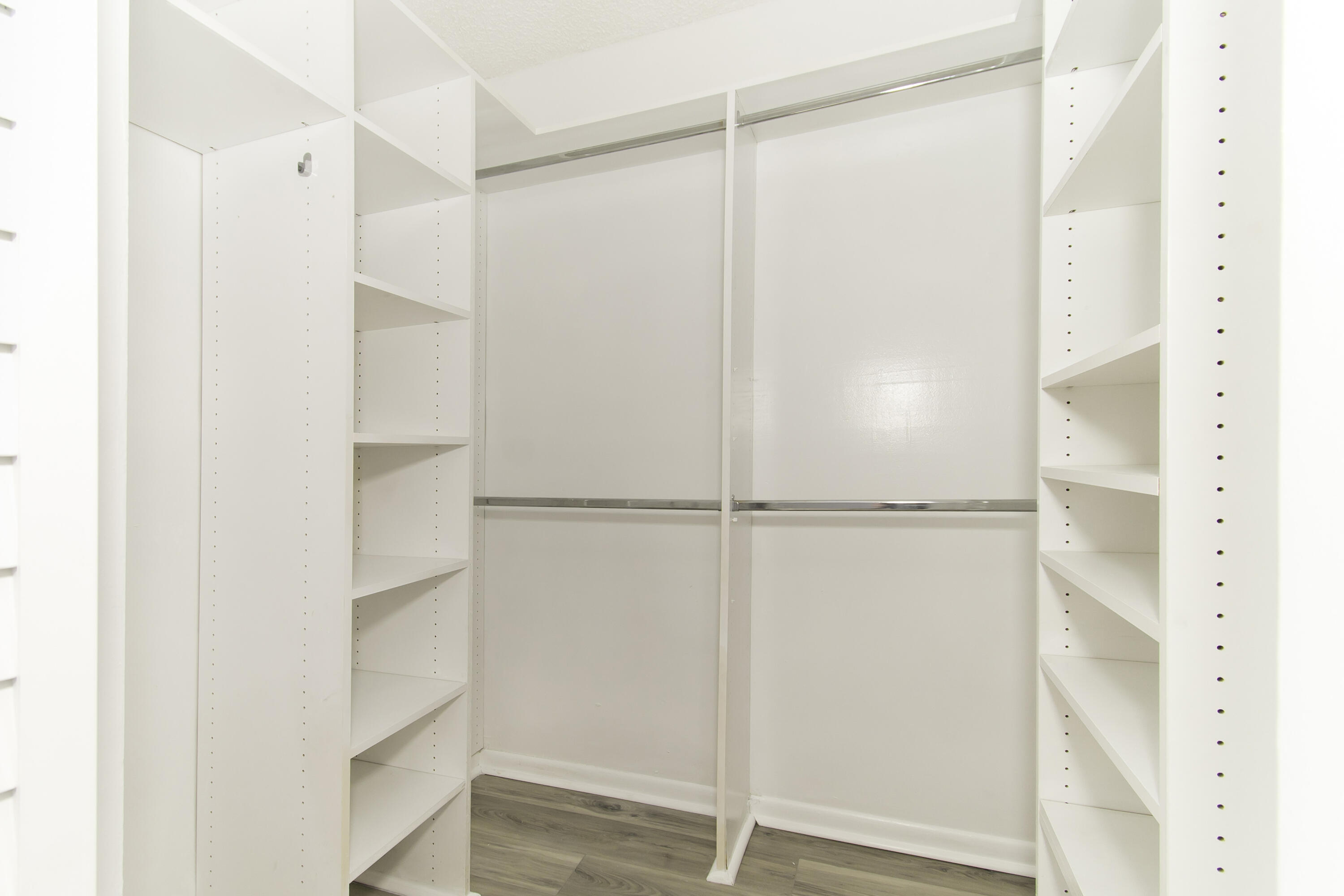 1571 Southwest 13th Drive Boca Raton, FL 33486 - Photo 10 of 21 a view of walk in closet with empty racks