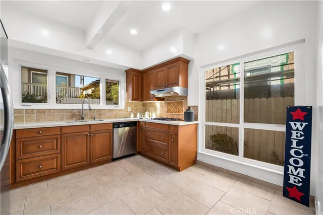 a kitchen with granite countertop a stove and a sink