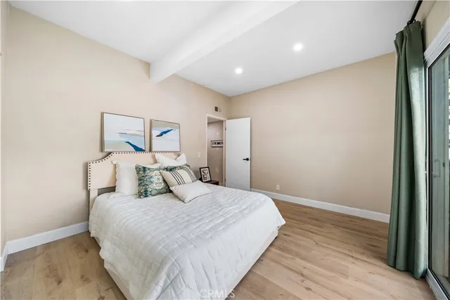 a bedroom with a bed and a painting