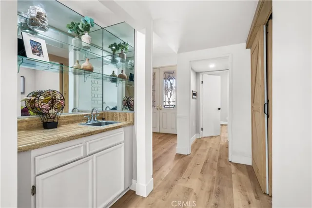 a bathroom with a sink and mirror with shower