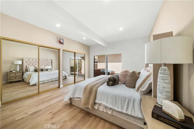 a bedroom with a large bed and a view of living room
