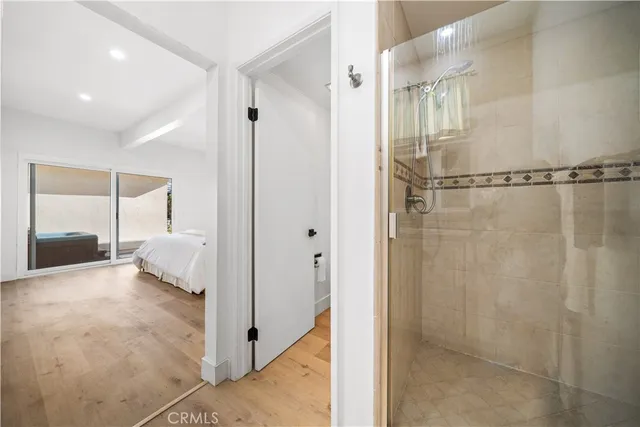 a bathroom with a shower and a glass door