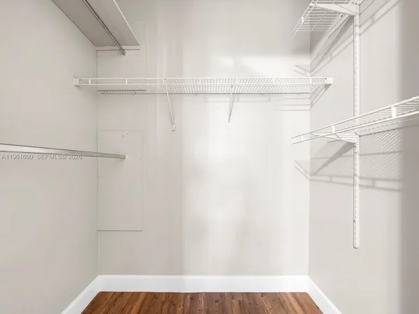 a view of walk in closet with empty racks