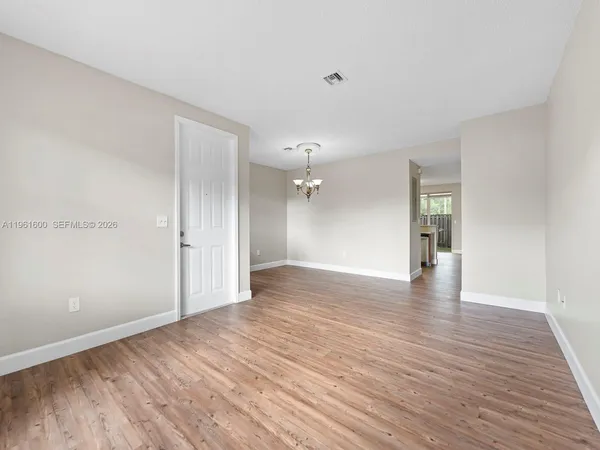 a view of an empty room and wooden floor