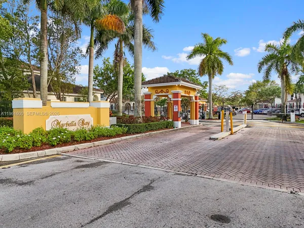 a palm tree sitting in front of a building