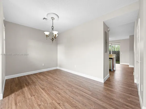 a view of a room with wooden floor
