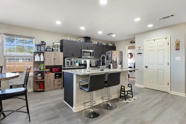 a kitchen with kitchen island cabinets and wooden floor