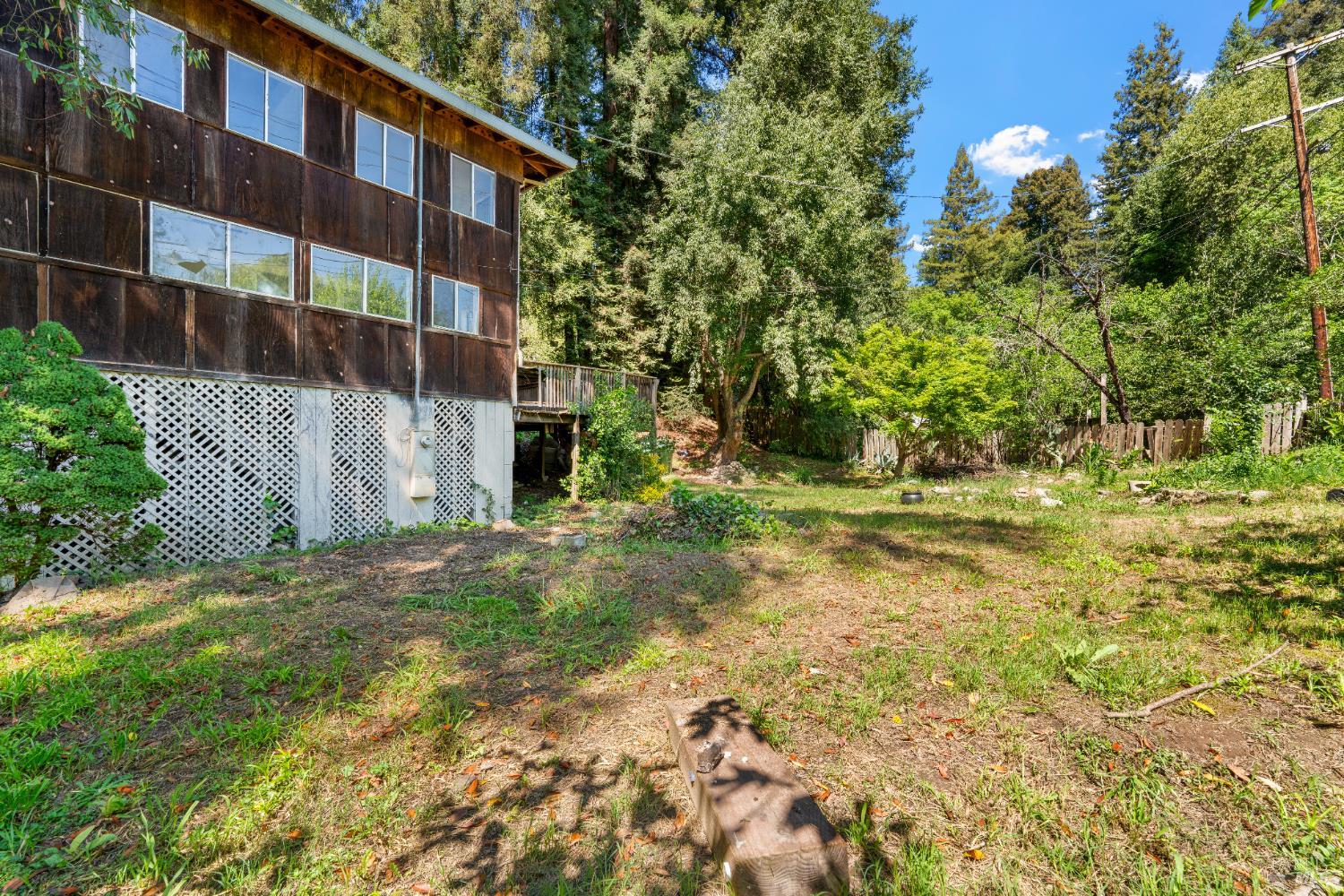 10991 River Road Forestville, CA 95436 - Photo 3 of 20 a view of a yard with plants and wooden fence