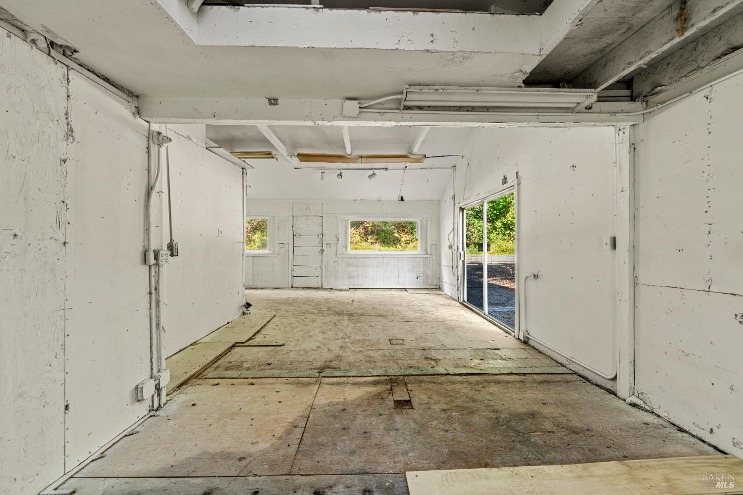 10991 River Road Forestville, CA 95436 - Photo 9 of 20 a view of a hallway with wooden floor and a refrigerator