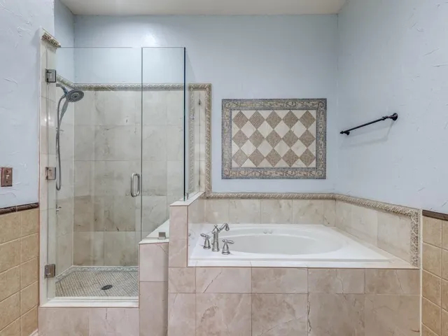 a bathroom with a bathtub and a shower