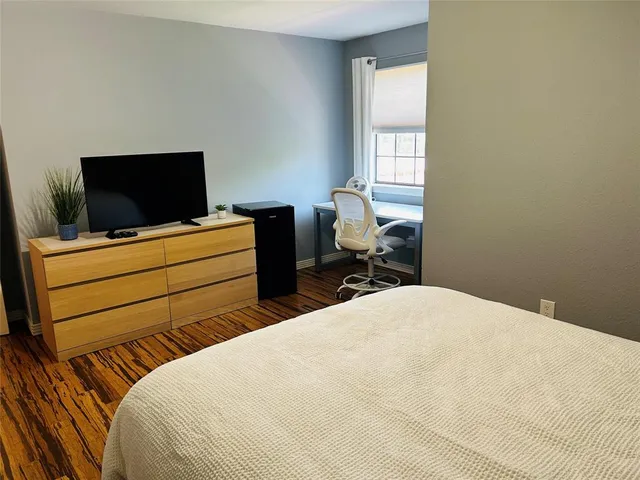 a bedroom with a bed and a flat screen tv