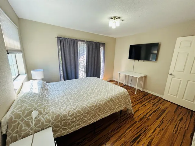 a bedroom with a bed and a flat screen tv