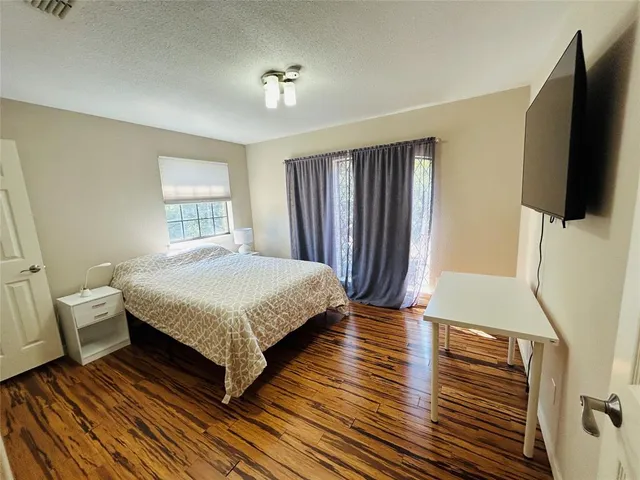 a bedroom with a bed and a flat screen tv