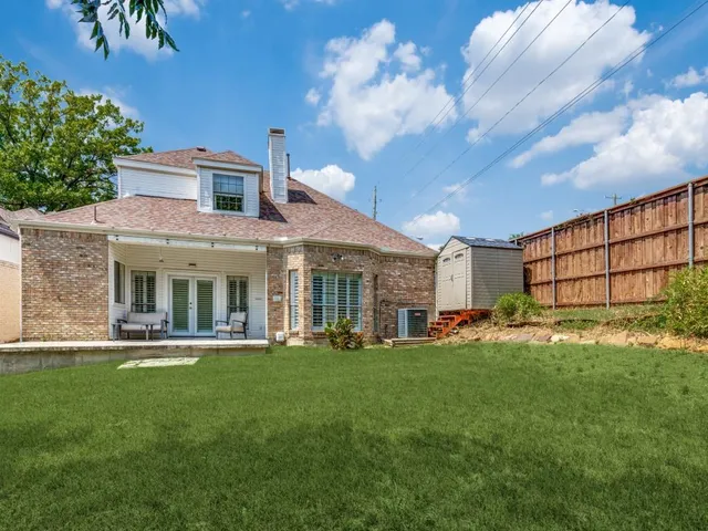 a front view of a house with a yard table and chairs