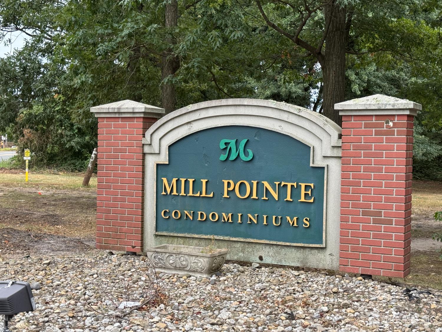 a sign broad in front of a brick building