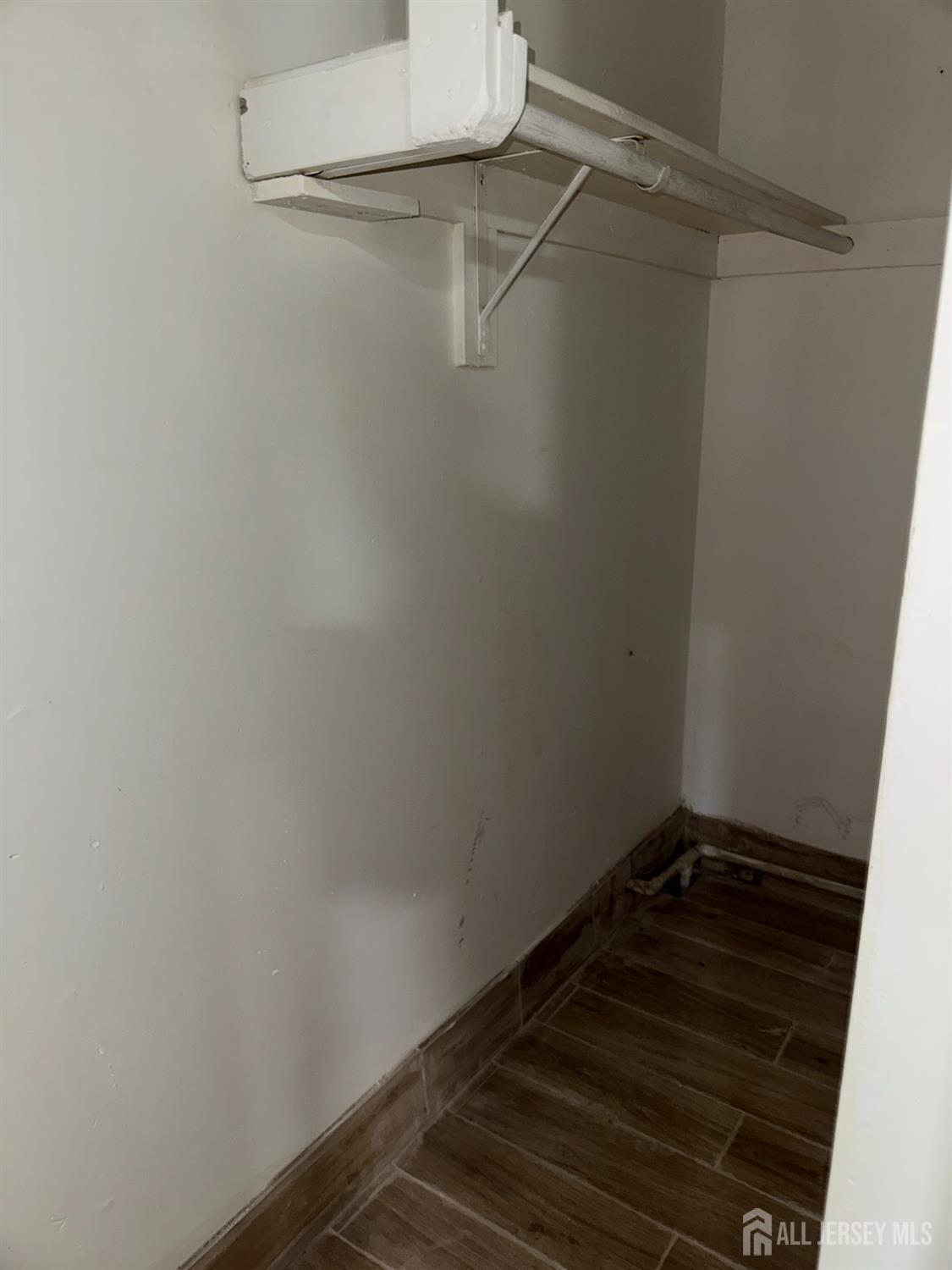 76 College Drive Edison, NJ 08817 - Photo 11 of 16 a view of a room with racks on the wall