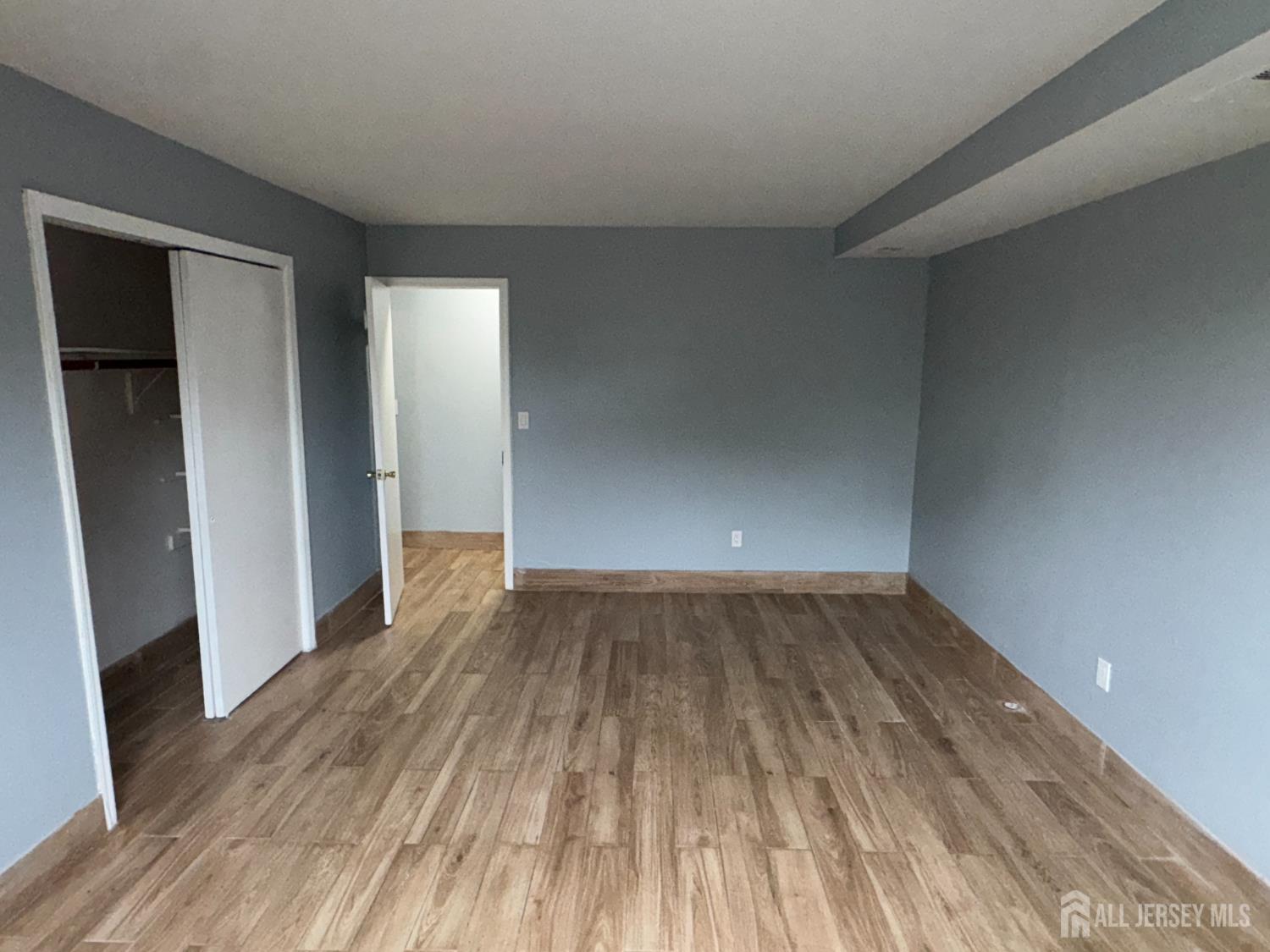 76 College Drive Edison, NJ 08817 - Photo 13 of 16 a view of a room with wooden floor