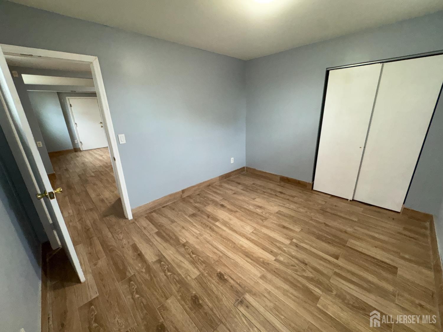 76 College Drive Edison, NJ 08817 - Photo 14 of 16 a view of a room with wooden floor