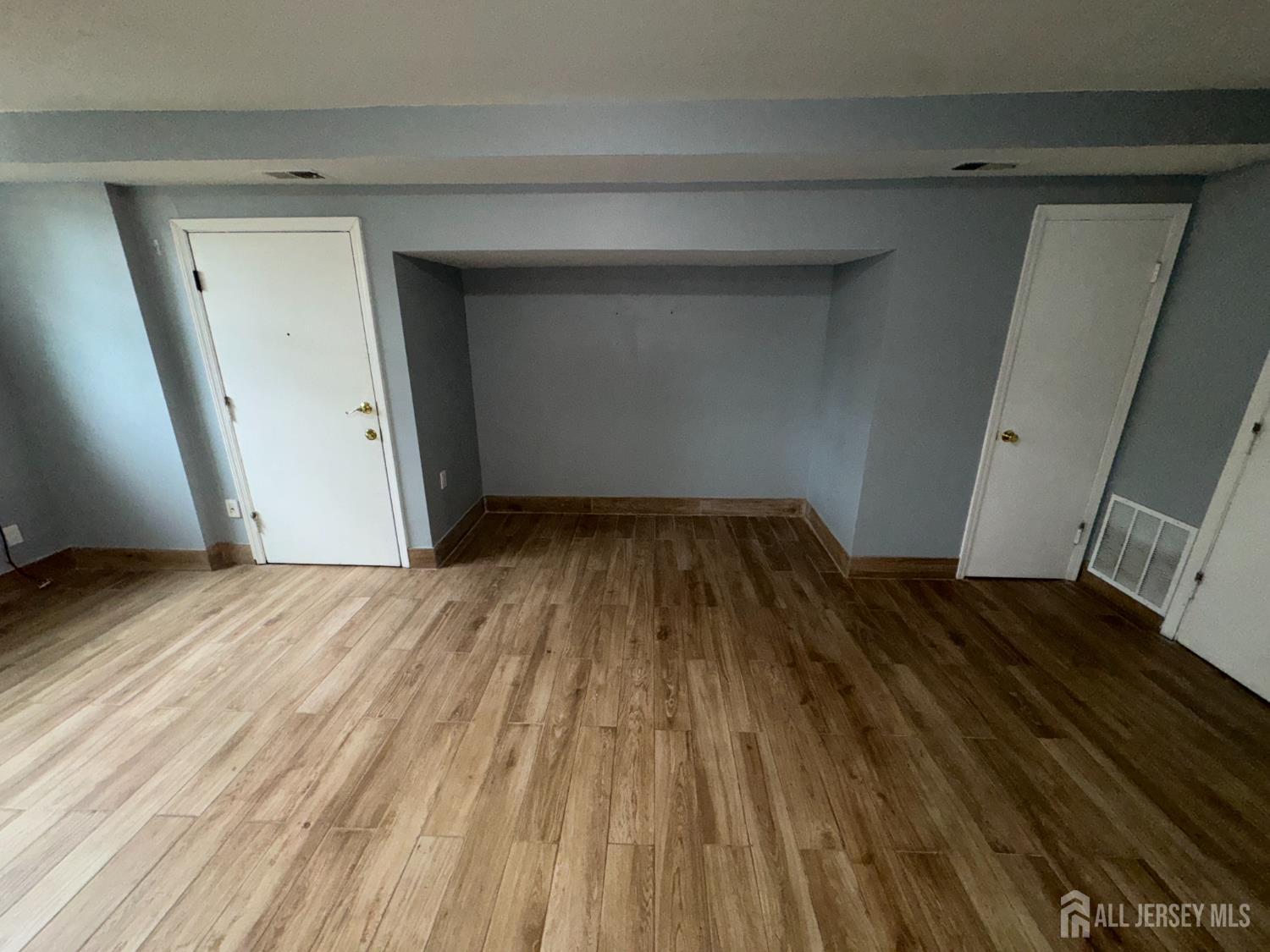 76 College Drive Edison, NJ 08817 - Photo 6 of 16 a view of empty room with wooden floor