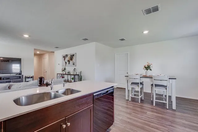 a kitchen with a sink and breakfast area