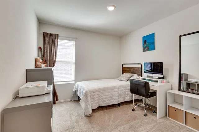 a bedroom with a workspace